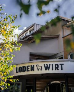 a sign for a hotel with a balcony on a building at Lodenwirt Residence in Vandoies