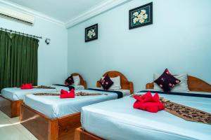 Postel nebo postele na pokoji v ubytování Golden Papaya Guesthouse