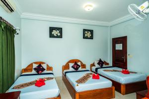 Postel nebo postele na pokoji v ubytování Golden Papaya Guesthouse