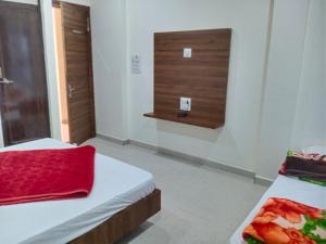 a room with two beds and a window in it at Hotel soham palace in Ujjain