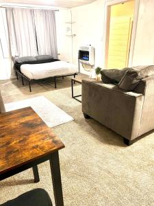 a living room with a couch and a table at Two Bedroom Villa Studio with fireplace & Living room in Detroit