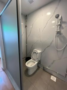 a small bathroom with a toilet and a shower at Duke Living in Singapore