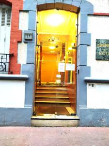 a door to a building with stairs in it at Hôtel Résidence Saint Ouen in Saint-Ouen