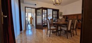 a dining room with a table and chairs at Villa "CENTRAL VILLAGE" in Županja