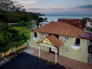 an aerial view of a house with the ocean in the background at GAIA Hotel in Tanjung Bungah