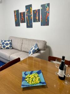 a table with a plate of grapes on top of it at Matchpoint Apartment in Sanremo