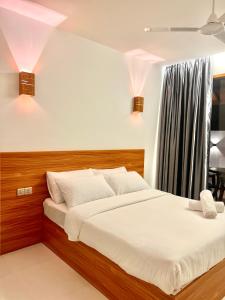 a bedroom with a large bed with white sheets at Vilu Residence in Maamigili +51 photos