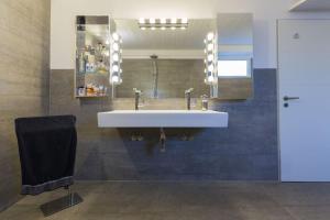 a bathroom with a white sink and a mirror at City-Loft with rooftop terrace - 19 persons in Hannover