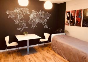 a bedroom with a bed and a white table and chairs at City-Loft with rooftop terrace - 19 persons in Hannover