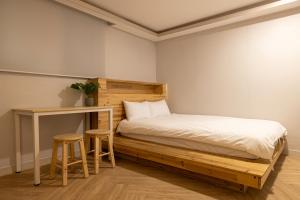 Un pat sau paturi într-o cameră la Woody Two Bedroom In Hongdae