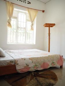 a bedroom with a bed with a quilt on it at KIVU SUNSET GUEST HOUSE in Gitesi