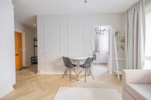 a living room with a table and two chairs at 30m2 studio - 500m from train station to Airport and Helsinki city centre in Vantaa