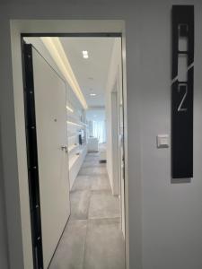 a hallway with a door leading into a room at The Dazzling Glimpse Acropolis Suites in Athens