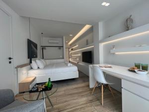 a bedroom with a bed and a desk in a room at The Dazzling Glimpse Acropolis Suites in Athens
