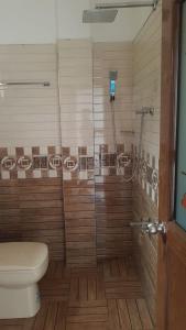 a bathroom with a toilet and a glass shower at Blue sky villa in Mirissa