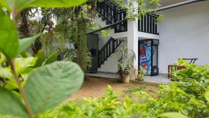 a house with a black and white front door at Blue sky villa in Mirissa +24 photos