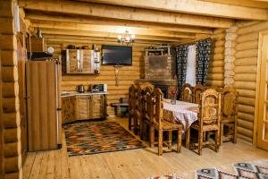 a kitchen with a table and chairs in a cabin at Karpaty Migovo in Migovo