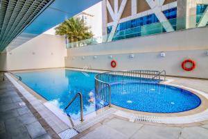 a large swimming pool in a building at VayK - Modern 2BD in the Marina near Beach in Dubai