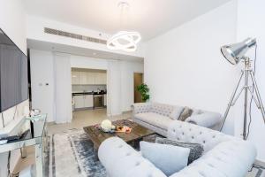 a living room with a couch and a table at VayK - Modern 2BD in the Marina near Beach in Dubai