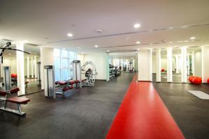 a gym with a red carpet in the middle at VayK - Modern 2BD in the Marina near Beach in Dubai