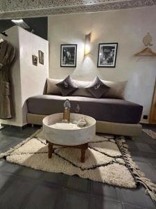 a living room with a couch and a coffee table at Riad Al Nubala in Marrakech