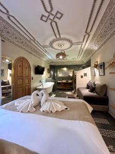 a hotel room with two swans on a bed at Riad Al Nubala in Marrakesh