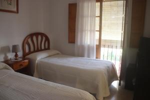 Postel nebo postele na pokoji v ubytování HOSTAL MONCADA