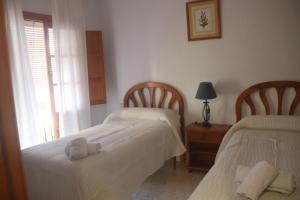 Postel nebo postele na pokoji v ubytování HOSTAL MONCADA