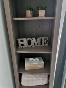 a book shelf with a home sign and a box at Maisonnette rénovée et son jardin in Châtellerault