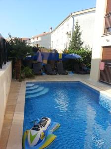 a swimming pool with a toy boat in the middle at Villa Patricija-apartmani in Poreč