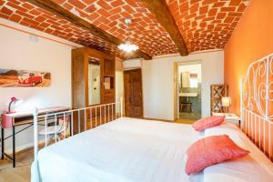 una camera da letto con un grande letto bianco in una stanza di Casa Nicola a Belveglio