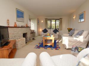 a living room with a couch and a fireplace at 4 Bed in Sherborne OOMEO in Chetnole