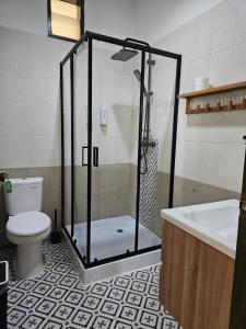 a bathroom with a shower and a toilet and a sink at Roemah Uli Cirebon in Cirebon