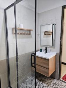 a bathroom with a sink and a shower at Roemah Uli Cirebon in Cirebon