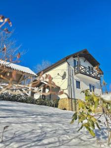 a building with a fence in front of it at Carpathian manor in Yaremche