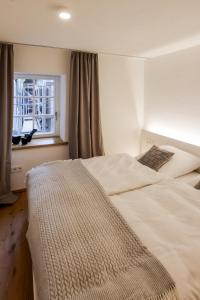 a bedroom with two beds and a window at Faust-Appartements 