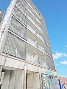 a tall white building with large windows at Kyoto - Hotel / Vacation STAY 73651 in Kyoto