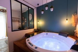 a large bath room with a large bath tub at Loveappart21 l'expérience Bien Être in Dijon