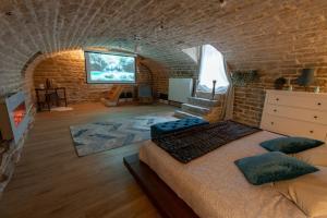 a bedroom with a large bed in a brick wall at Loveappart21 l'expérience Bien Être in Dijon