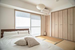 a bedroom with a bed with a pillow on it at Kyoto - Hotel / Vacation STAY 73651 in Kyoto