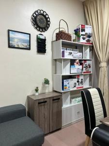 a living room with a table and a chair at BOTANI LOFT HOMESTAY in Ipoh