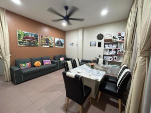 a living room with a table and a couch at BOTANI LOFT HOMESTAY in Ipoh