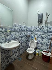 a bathroom with a toilet and a sink at BOTANI LOFT HOMESTAY in Ipoh