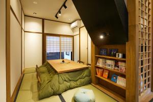 a room with a table and a book shelf at Machizukitei - Vacation STAY 82078 in Kyoto