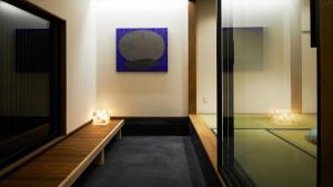 a hallway with a table and a painting on the wall at Machizukitei - Vacation STAY 82078 in Kyoto