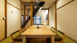 a wooden table in a room with a staircase at Machizukitei - Vacation STAY 82078 in Kyoto