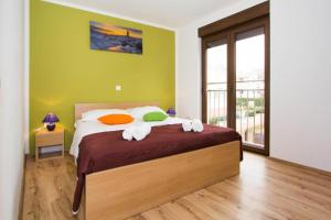 a bedroom with a large bed with green walls at Villa Patricija-apartmani in Poreč +43 photos