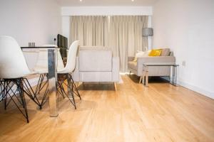 a living room with a table and chairs and a couch at Stunning 1-Bed Apartment in London in Hendon