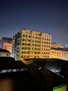 a tall building in the middle of a city at Quiet studio in downtown in Cairo