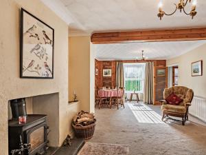 a living room with a fireplace and a table at 3 Bed in Briston 90184 in Briston